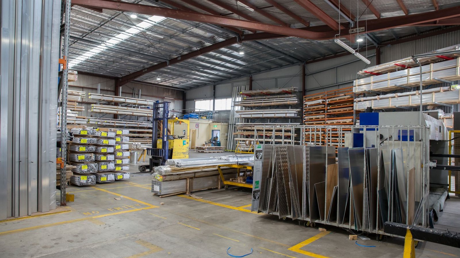 Extruded aluminium profile sections stacked in a rack