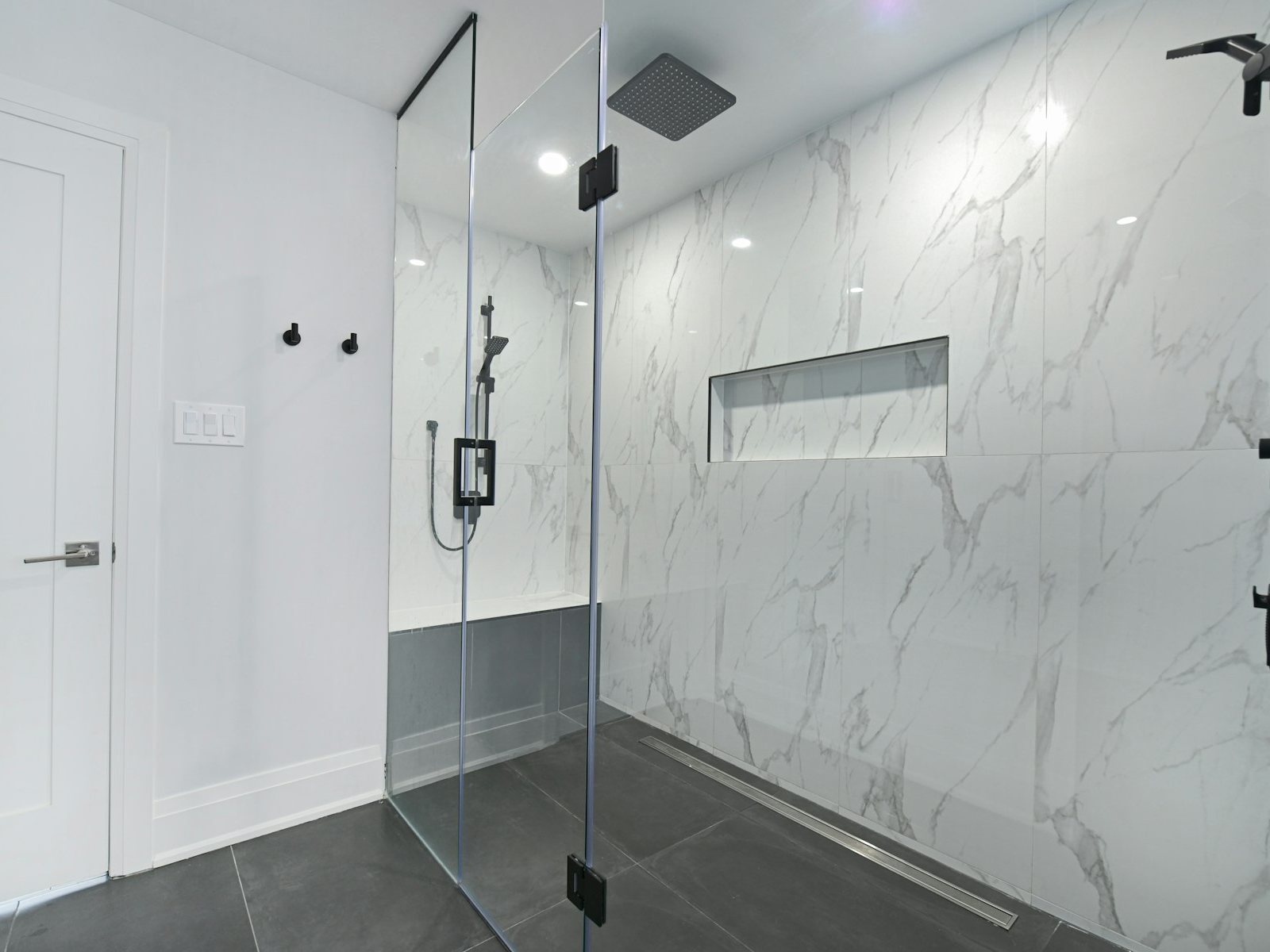 Frameless glass shower enclosure