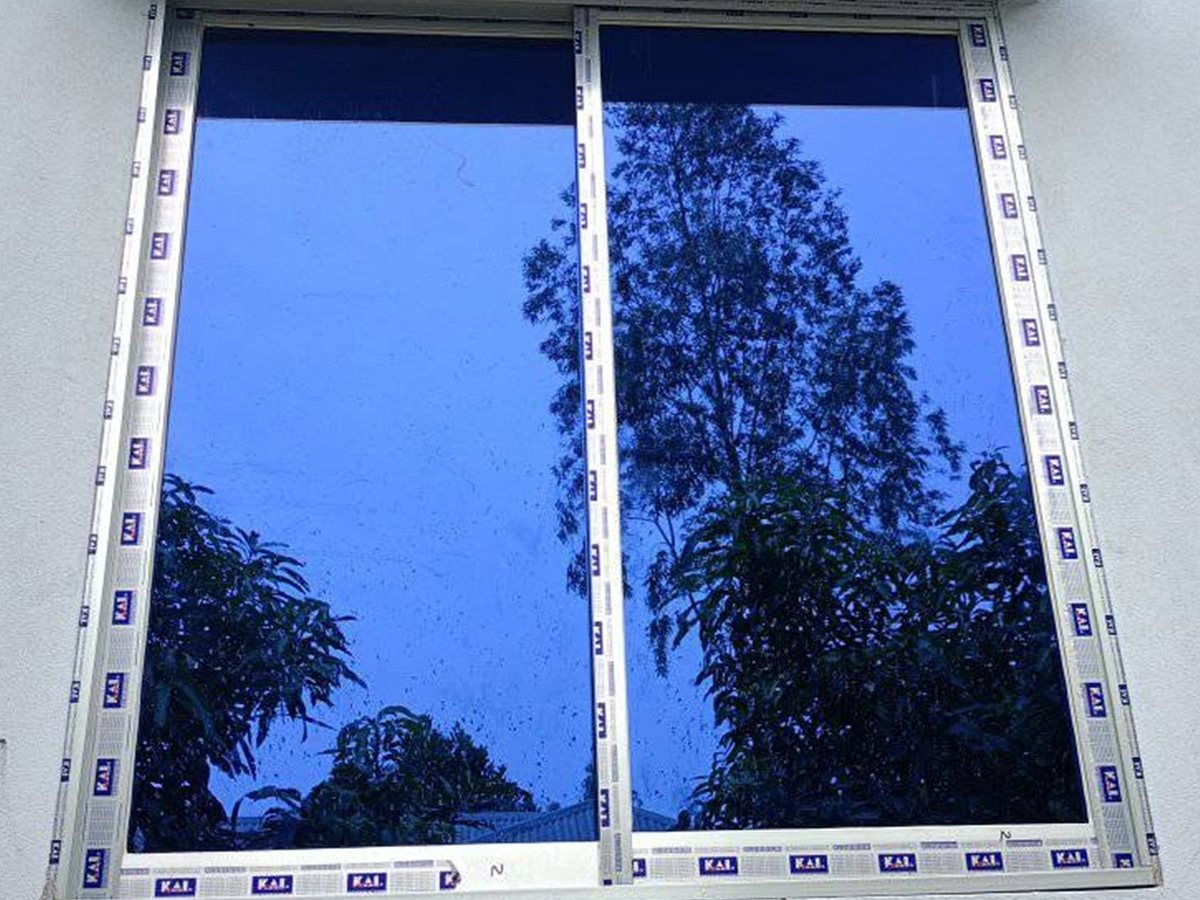 Finished KAI 4-inch silver sliding window with reflective glass, protective film still on, Chandrima Udyan