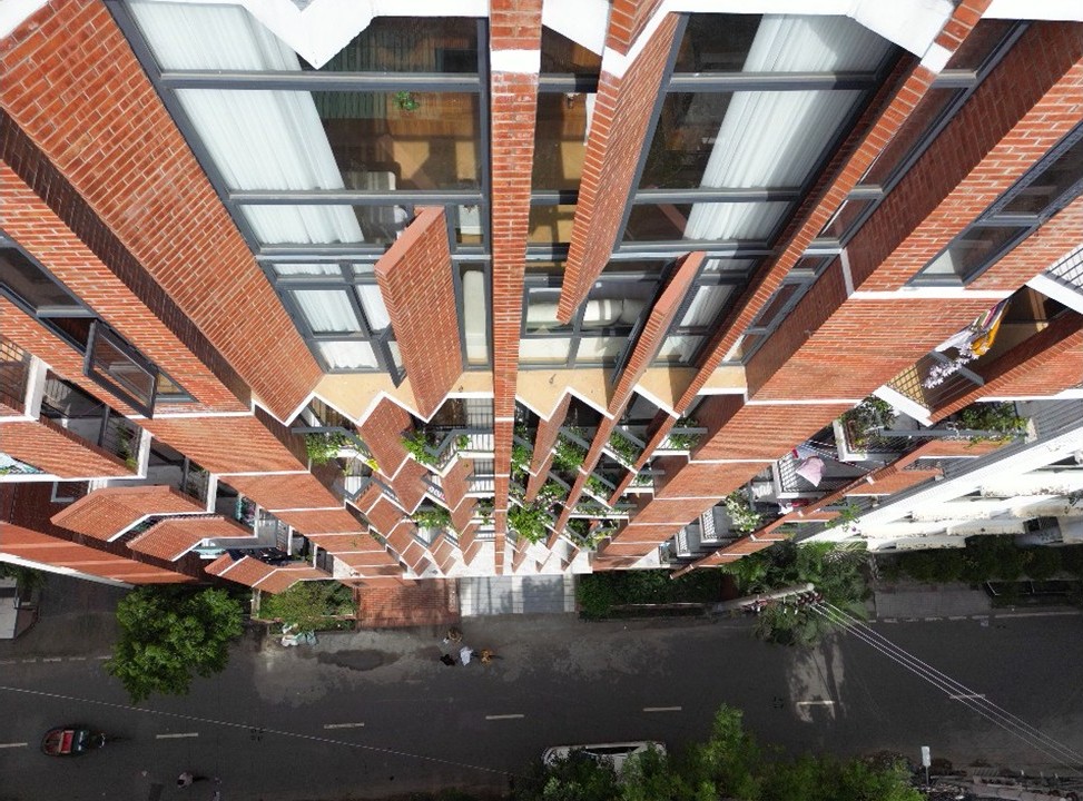 Drone view down the Mohammadia Housing façade: brick fins with glazed openings between them