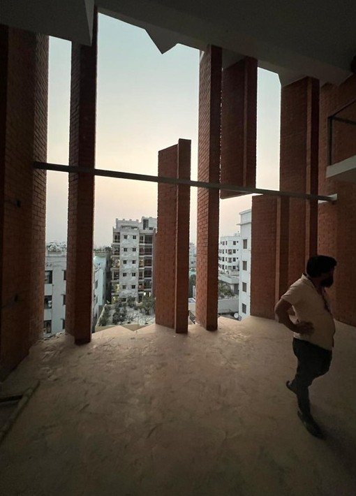 Full-height opening between brick fins before glazing, seen from inside